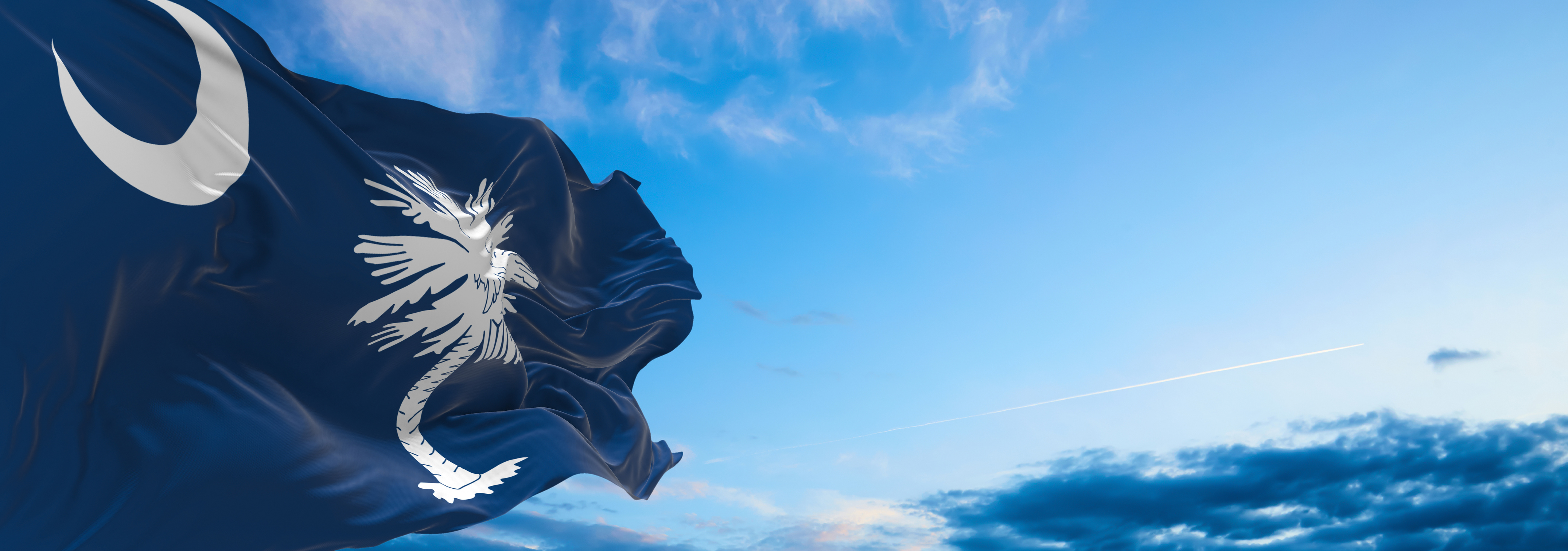 Flag of South Carolina at Cloudy Sky Background on Sunset